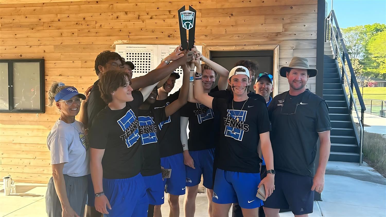  Florence Boys tennis holds up their trophy in victory